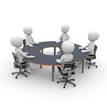 persone stilizzate intorno ad un tavolo in riunione.